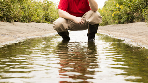 a graduate student conducting a water quality test experiment 